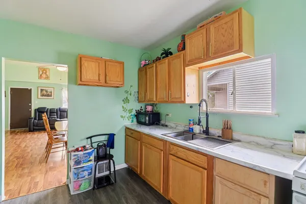 a kitchen with a sink cabinets and window