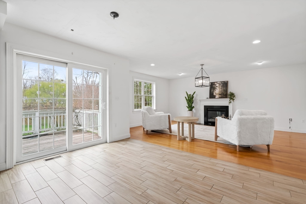30 Neponset Street Walpole, MA 02071 - Photo 19 of 41 a living room with furniture a dining table and a fireplace