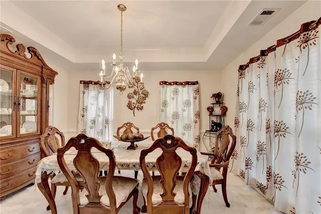 a view of a dining room with furniture and chandelier