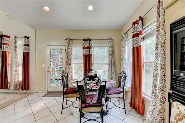 a living room with furniture and a view of kitchen