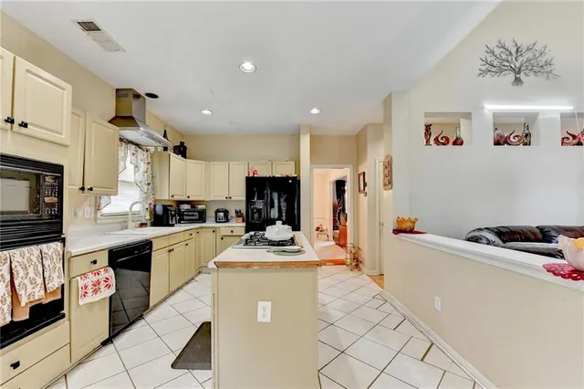 a living room with furniture and a view of kitchen