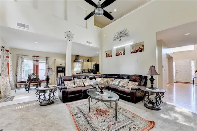 a spacious bedroom with a bed and a ceiling fan