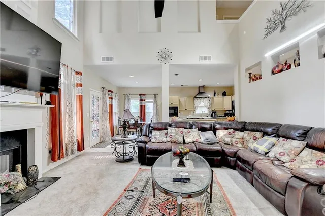 a spacious bedroom with a bed and a chandelier