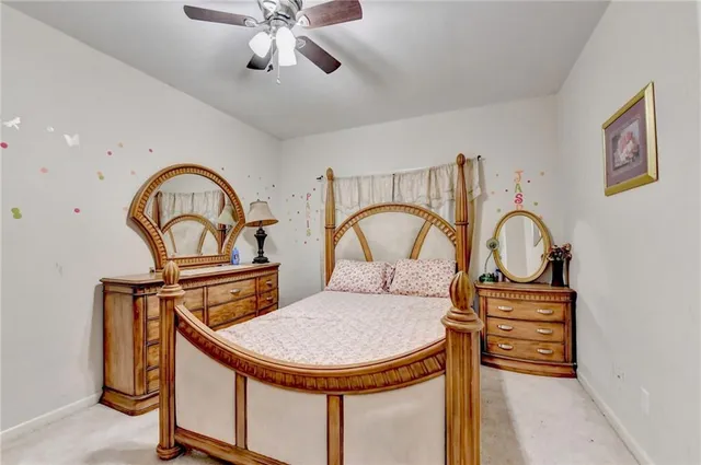 a bedroom with a bed and a ceiling fan