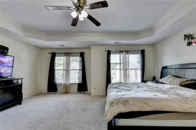 a bedroom with a bed and a tv