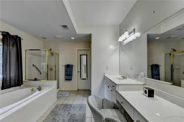 a bedroom with a bed and a flat tv screen on dresser