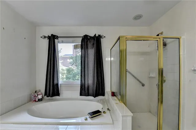 a view of a house with a yard potted plants and a table
