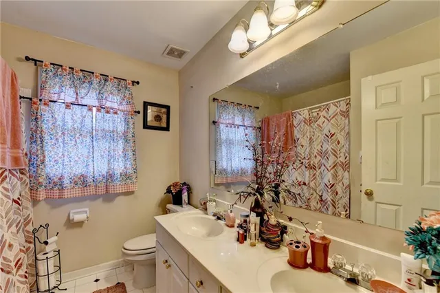 an aerial view of a house with a garden and trees