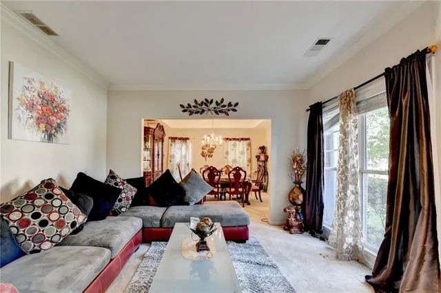 a view of a dining room with furniture and chandelier