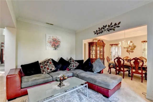 a view of a dining room with furniture and chandelier