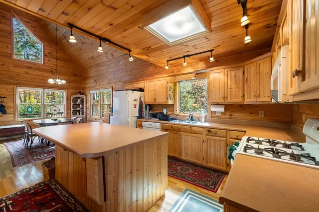 a kitchen with stainless steel appliances granite countertop a sink a stove and a refrigerator