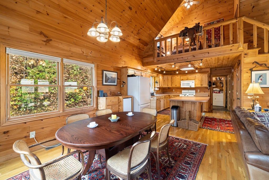 254 Aries Lane Blue Ridge, GA 30513 - Photo 13 of 43 a view of a dining room with furniture a chandelier and wooden floor