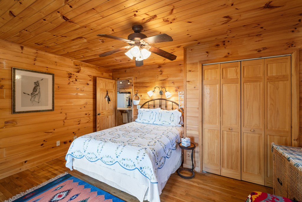 254 Aries Lane Blue Ridge, GA 30513 - Photo 16 of 43 a bedroom with a bed and a mirror