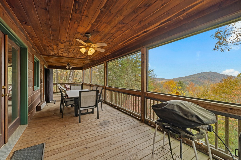 254 Aries Lane Blue Ridge, GA 30513 - Photo 20 of 43 a view of a balcony with furniture and wooden floor