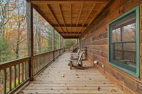 a view of a porch with wooden floor and iron stairs