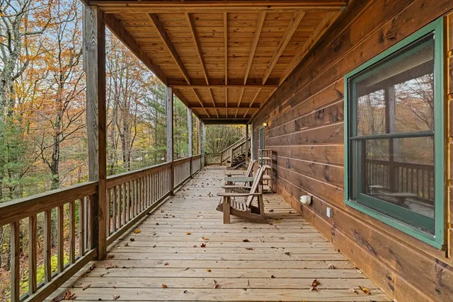 a view of a porch with wooden floor and iron stairs