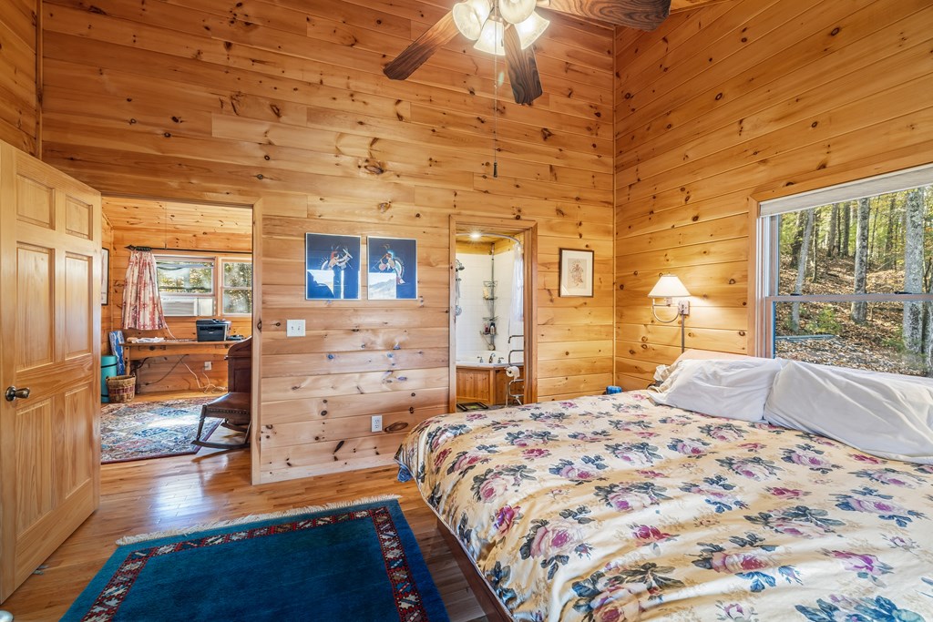 254 Aries Lane Blue Ridge, GA 30513 - Photo 28 of 43 a bedroom with a bed and wooden floor