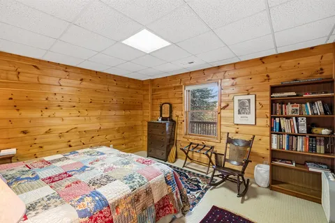 a bedroom with a bed and a book shelf