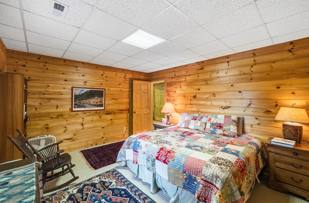 254 Aries Lane Blue Ridge, GA 30513 - Photo 37 of 43 a bedroom with a bed and wooden floor