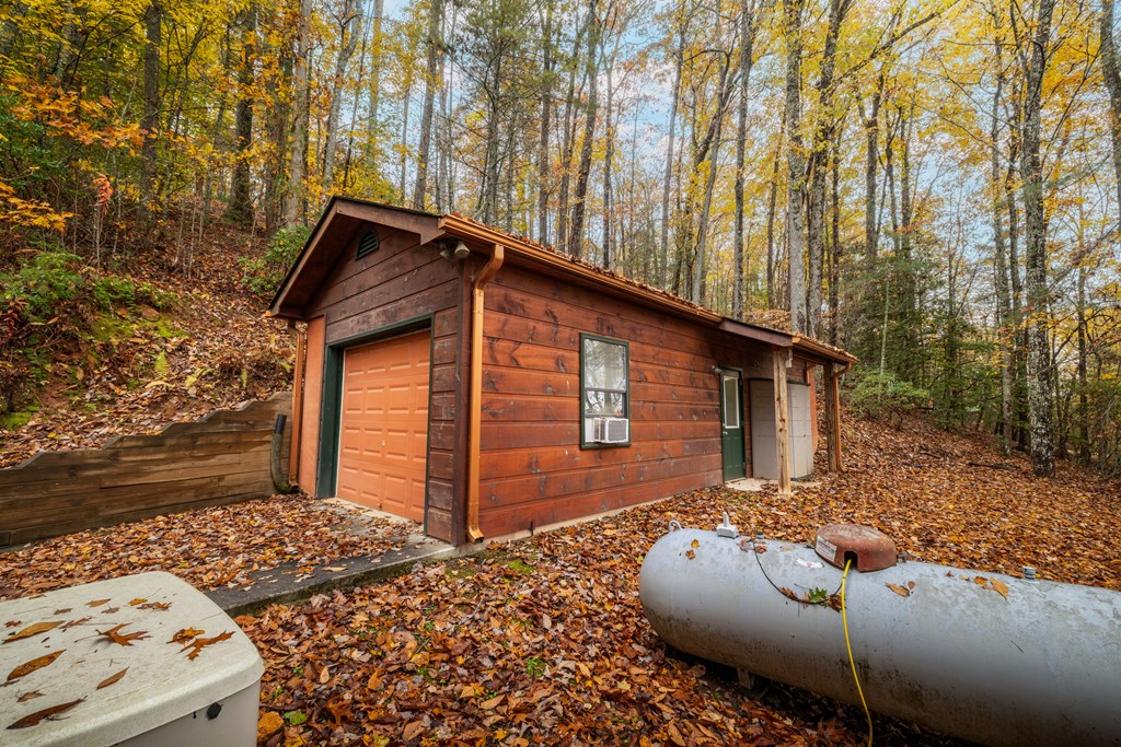 254 Aries Lane Blue Ridge, GA 30513 - Photo 38 of 43 a backyard of a house with large trees and outdoor seating
