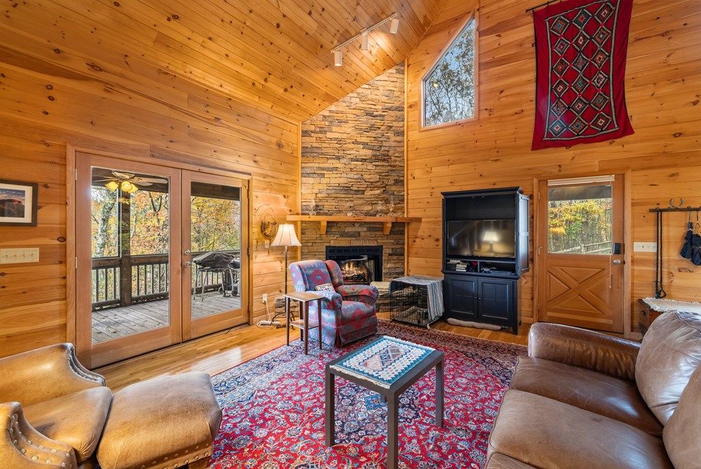 254 Aries Lane Blue Ridge, GA 30513 - Photo 10 of 43 a living room with furniture a fireplace and a flat screen tv
