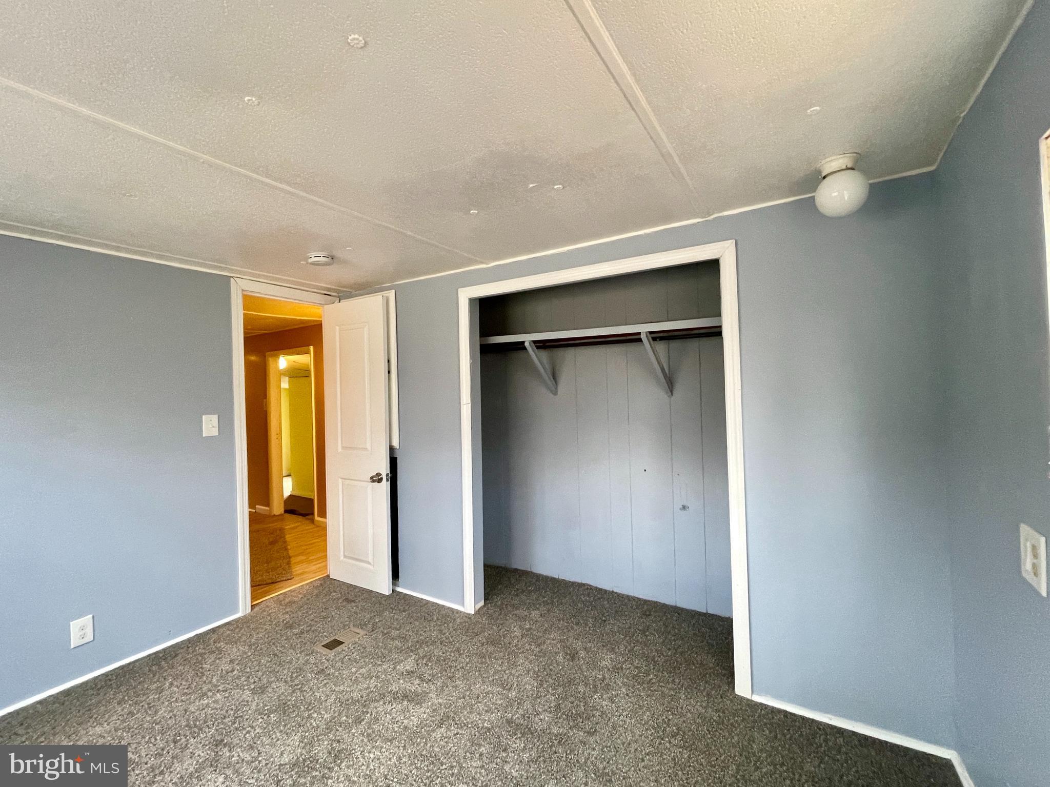 541 Fern Road Millville, NJ 08332 - Photo 12 of 15 an empty room with closet and wooden door