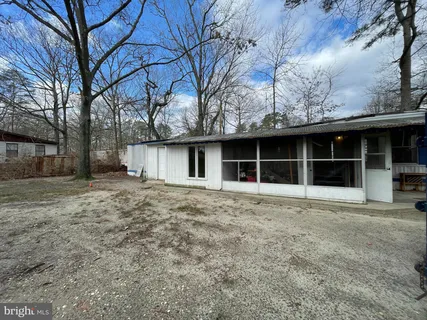 a view of a house with a large window and a large tree