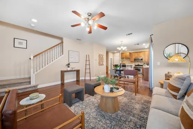 a view of a dining room with furniture a chandelier and wooden floor