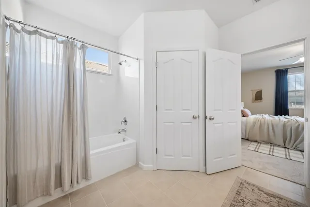 a bathroom with a bathtub and a shower