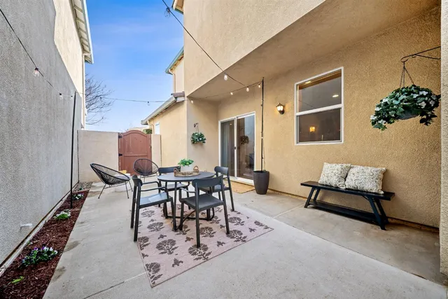 a dining room with furniture and a potted plant