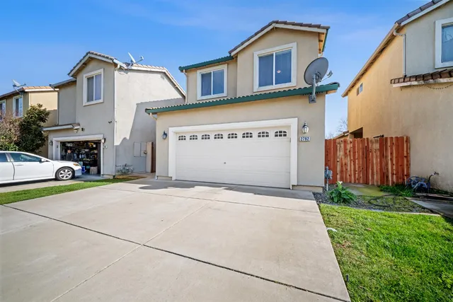 a front view of a house with a yard and garage