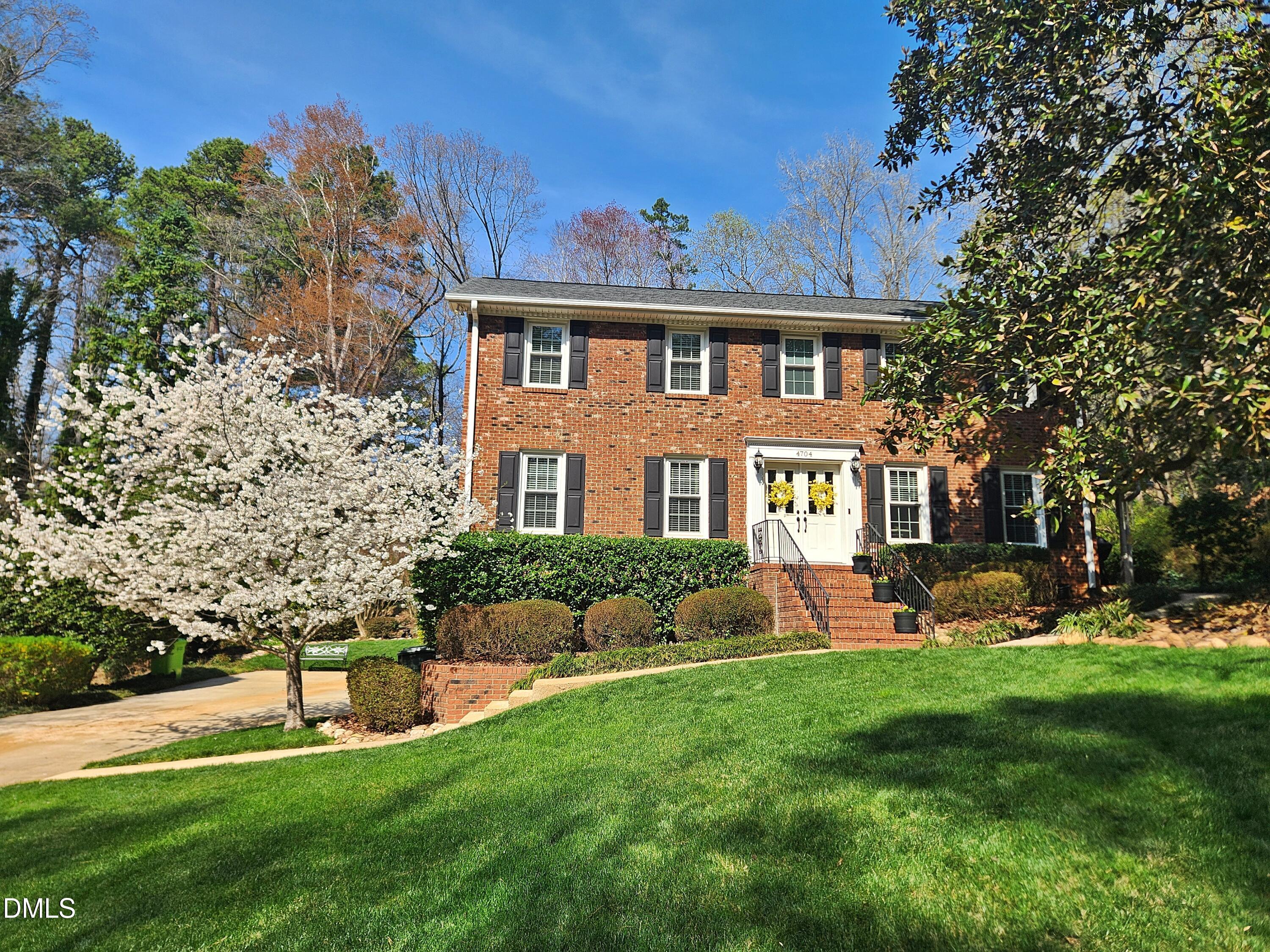 4704 Oak Park Road Raleigh, NC 27612 - Photo 1 of 62 a front view of a house with a yard table and chairs