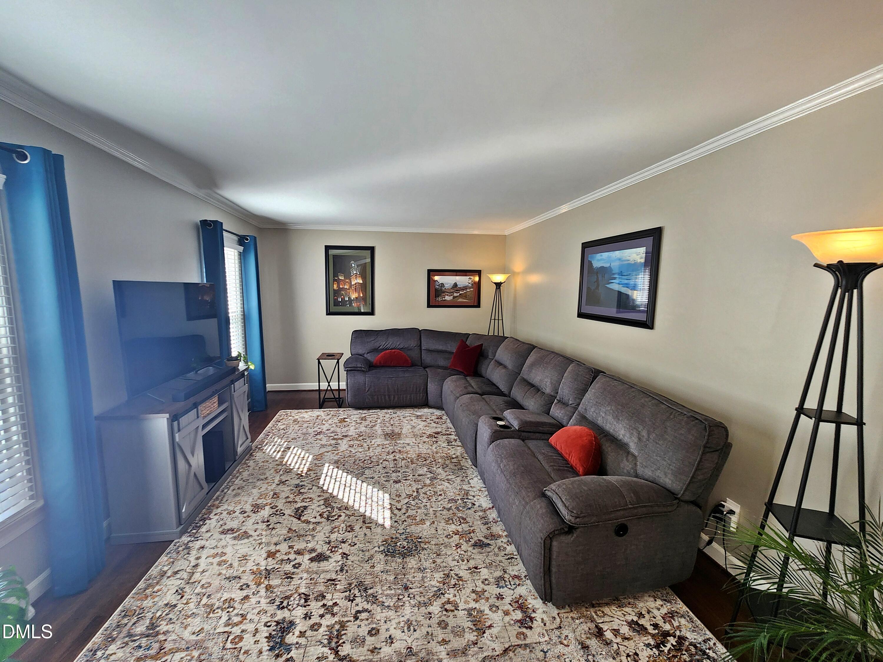 4704 Oak Park Road Raleigh, NC 27612 - Photo 16 of 62 a living room with furniture and a flat screen tv