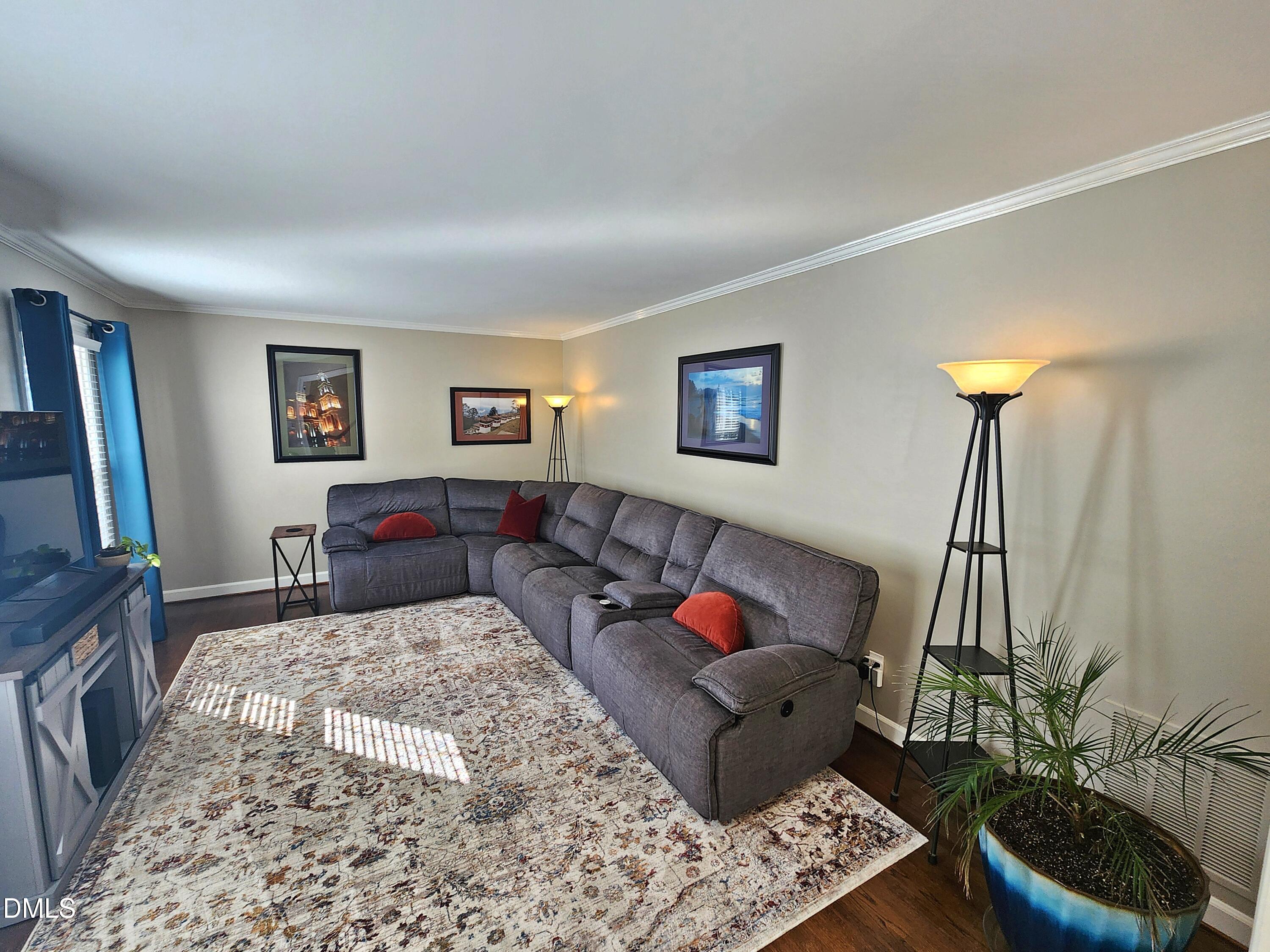 4704 Oak Park Road Raleigh, NC 27612 - Photo 17 of 62 a living room with furniture and a flat screen tv