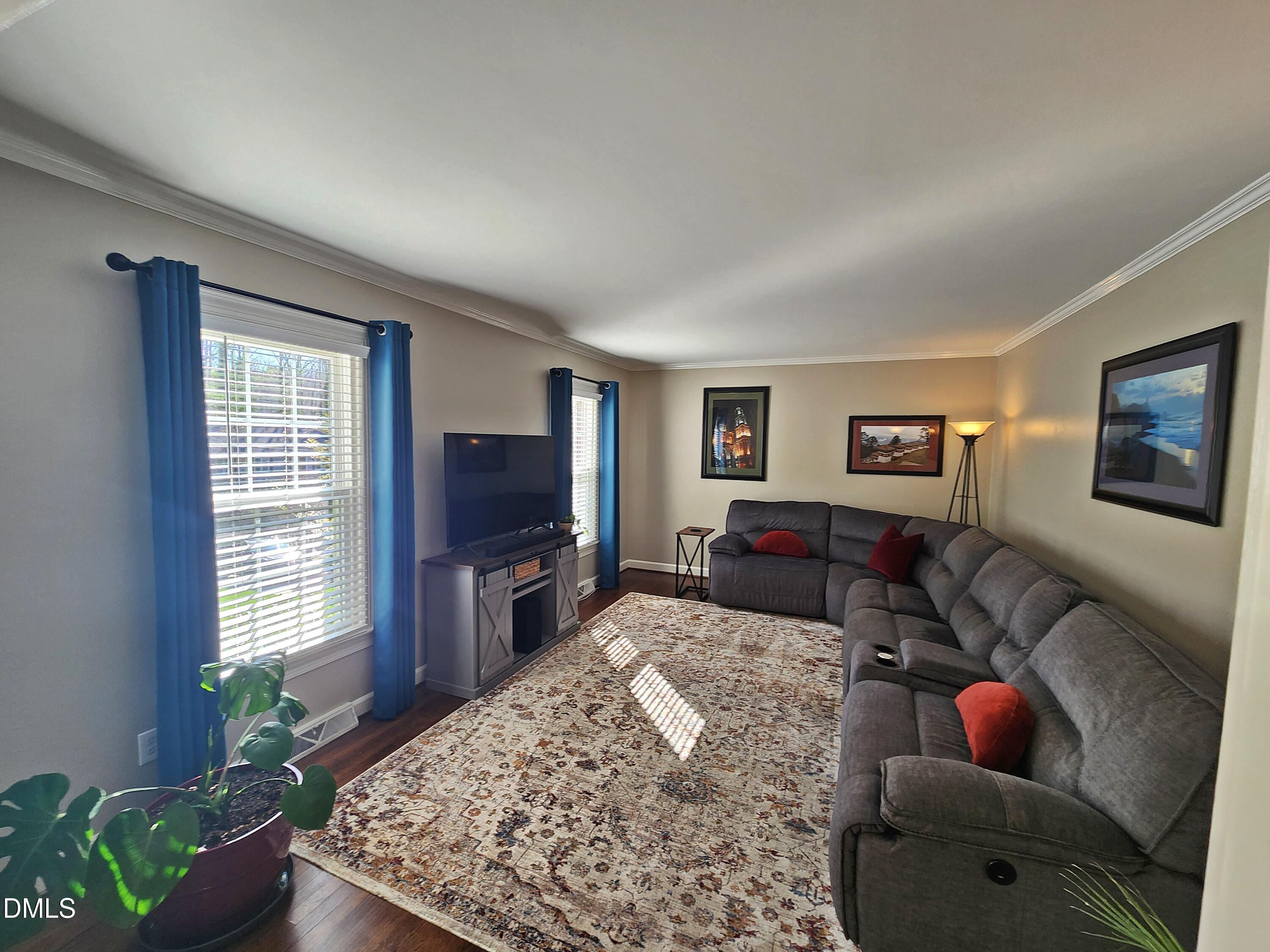 4704 Oak Park Road Raleigh, NC 27612 - Photo 18 of 62 a living room with furniture and a flat screen tv