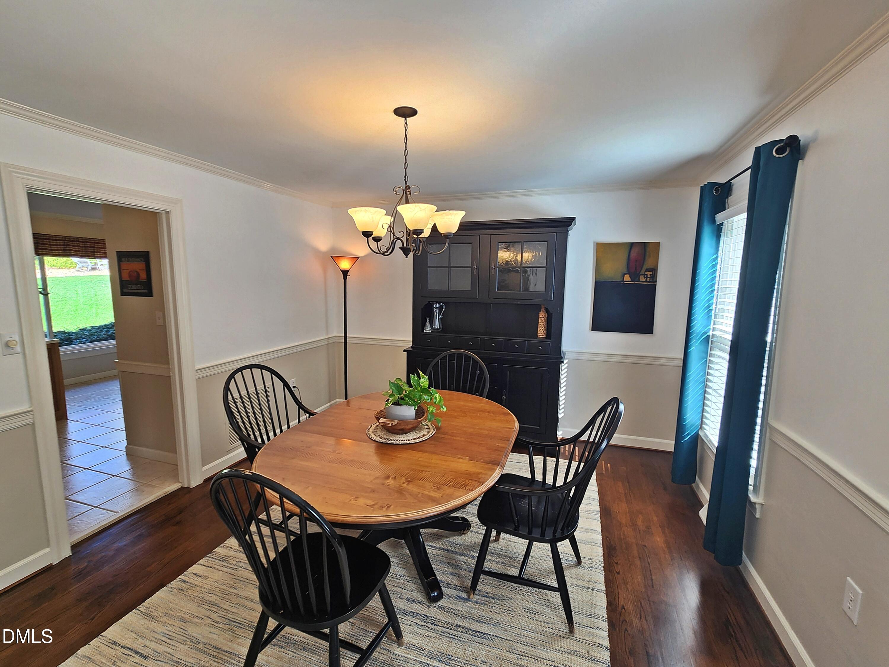 4704 Oak Park Road Raleigh, NC 27612 - Photo 20 of 62 a view of a dining room with furniture and wooden floor