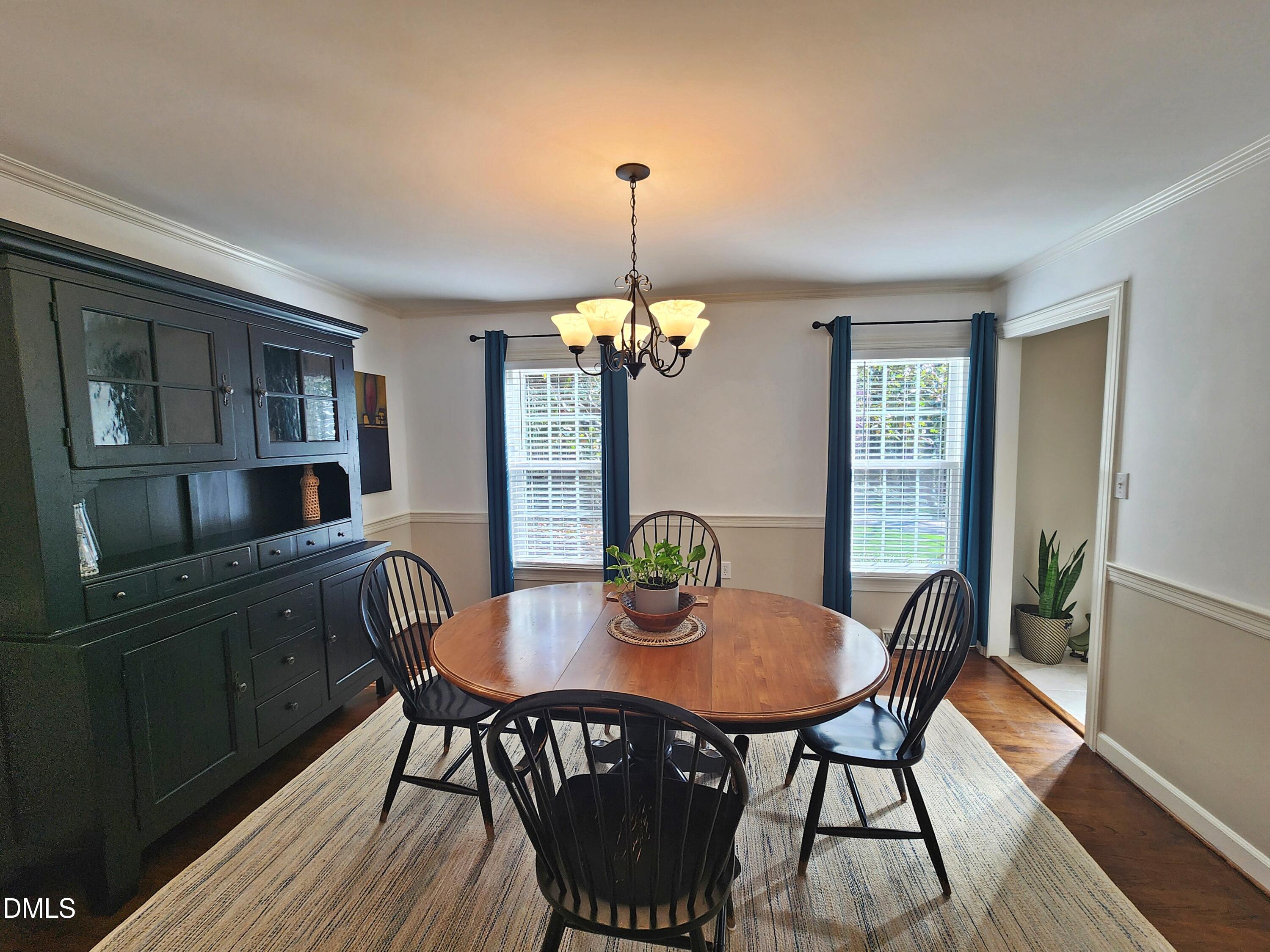 4704 Oak Park Road Raleigh, NC 27612 - Photo 21 of 62 a view of a dining room with furniture window and wooden floor