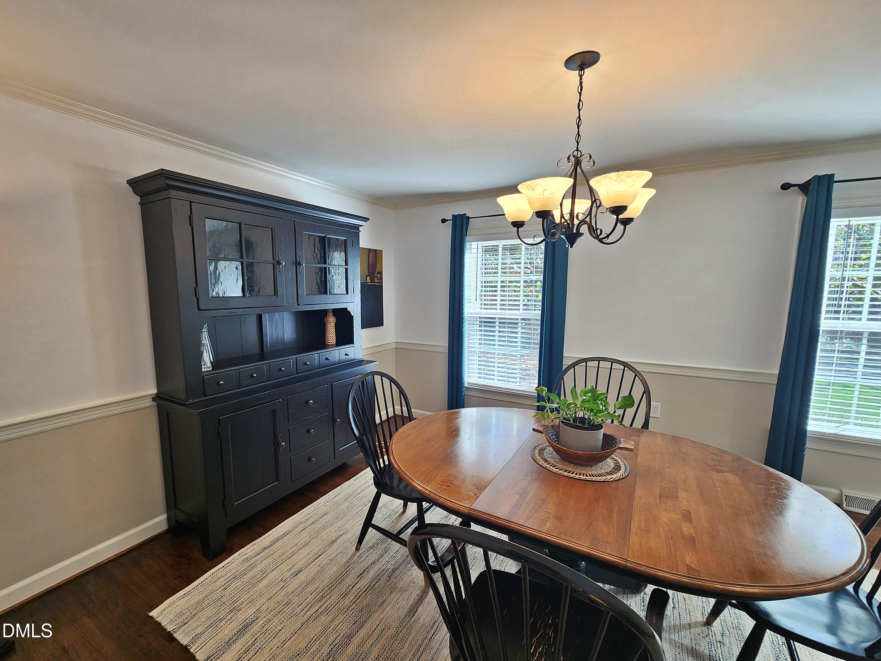 4704 Oak Park Road Raleigh, NC 27612 - Photo 22 of 62 a view of a dining room with furniture window and wooden floor