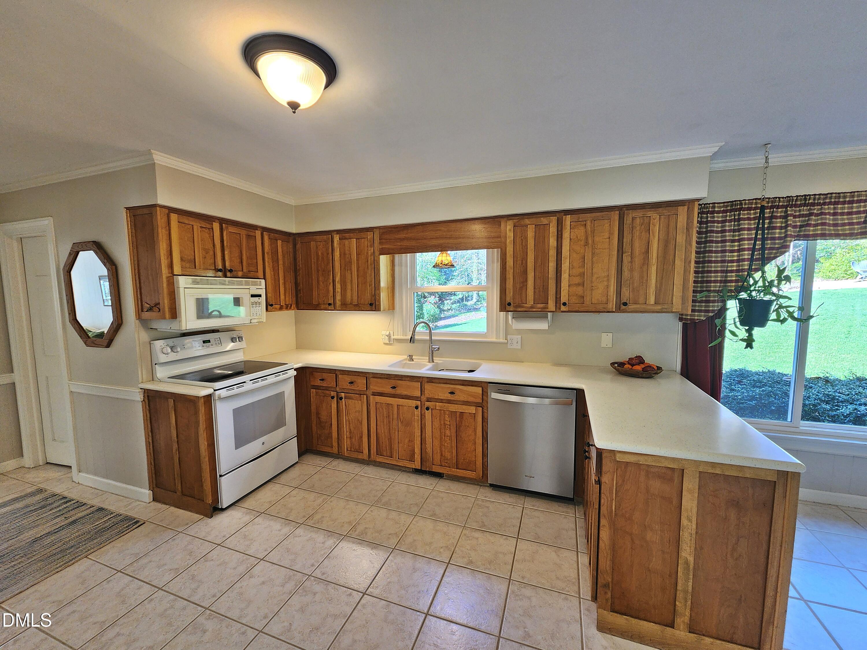 4704 Oak Park Road Raleigh, NC 27612 - Photo 23 of 62 a kitchen with a stove sink and a microwave