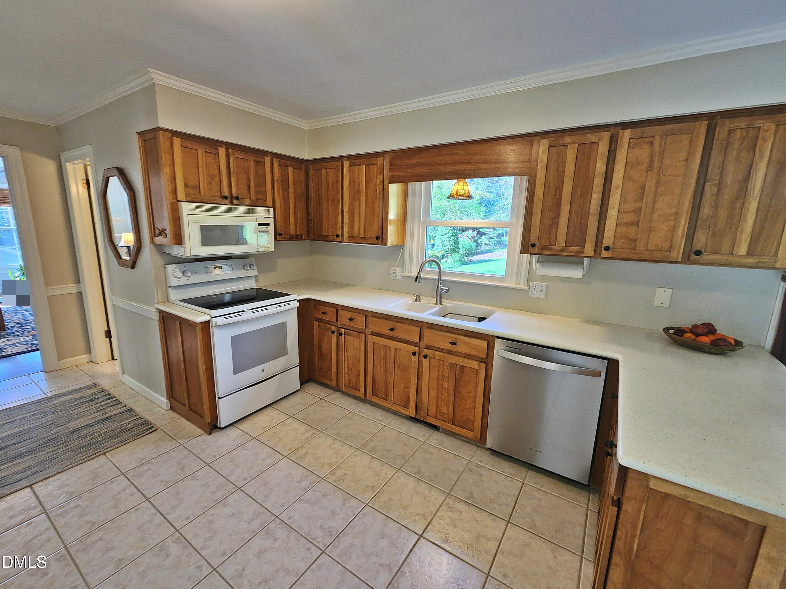 4704 Oak Park Road Raleigh, NC 27612 - Photo 25 of 62 a kitchen with stainless steel appliances granite countertop a stove a sink dishwasher and a refrigerator