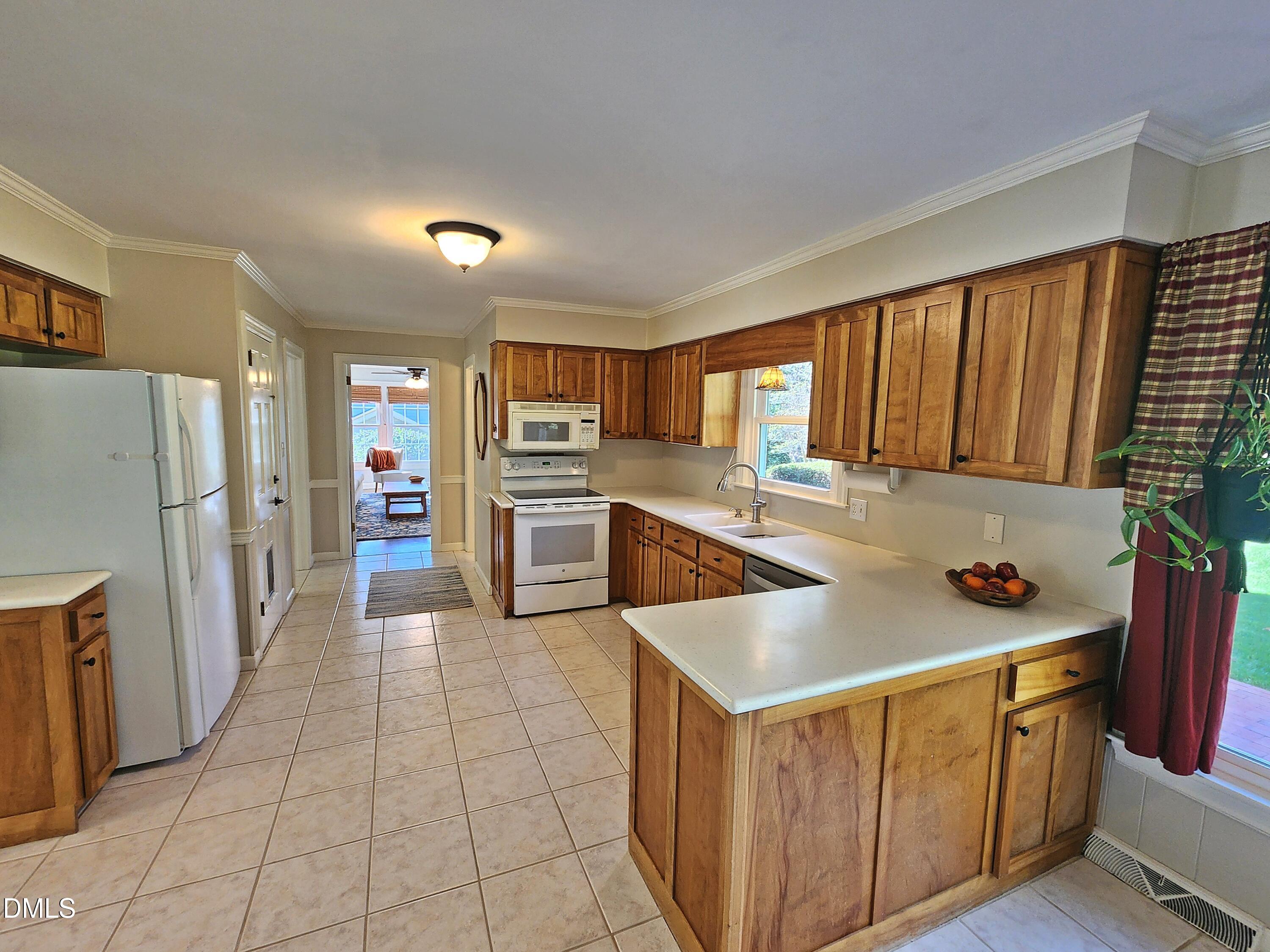 4704 Oak Park Road Raleigh, NC 27612 - Photo 26 of 62 a kitchen with stainless steel appliances granite countertop a refrigerator and a stove top oven