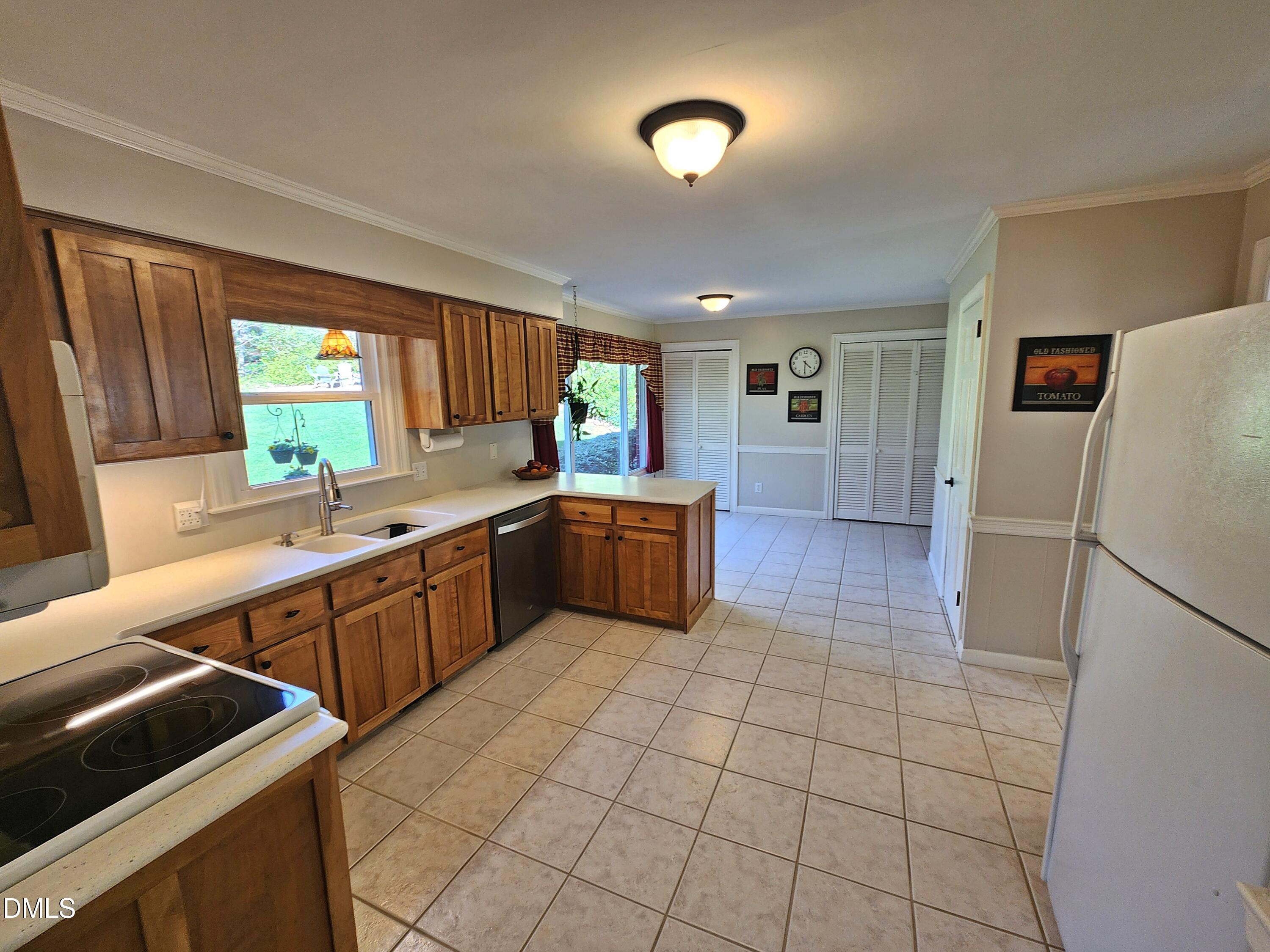 4704 Oak Park Road Raleigh, NC 27612 - Photo 30 of 62 a kitchen with a sink a counter top space and cabinets