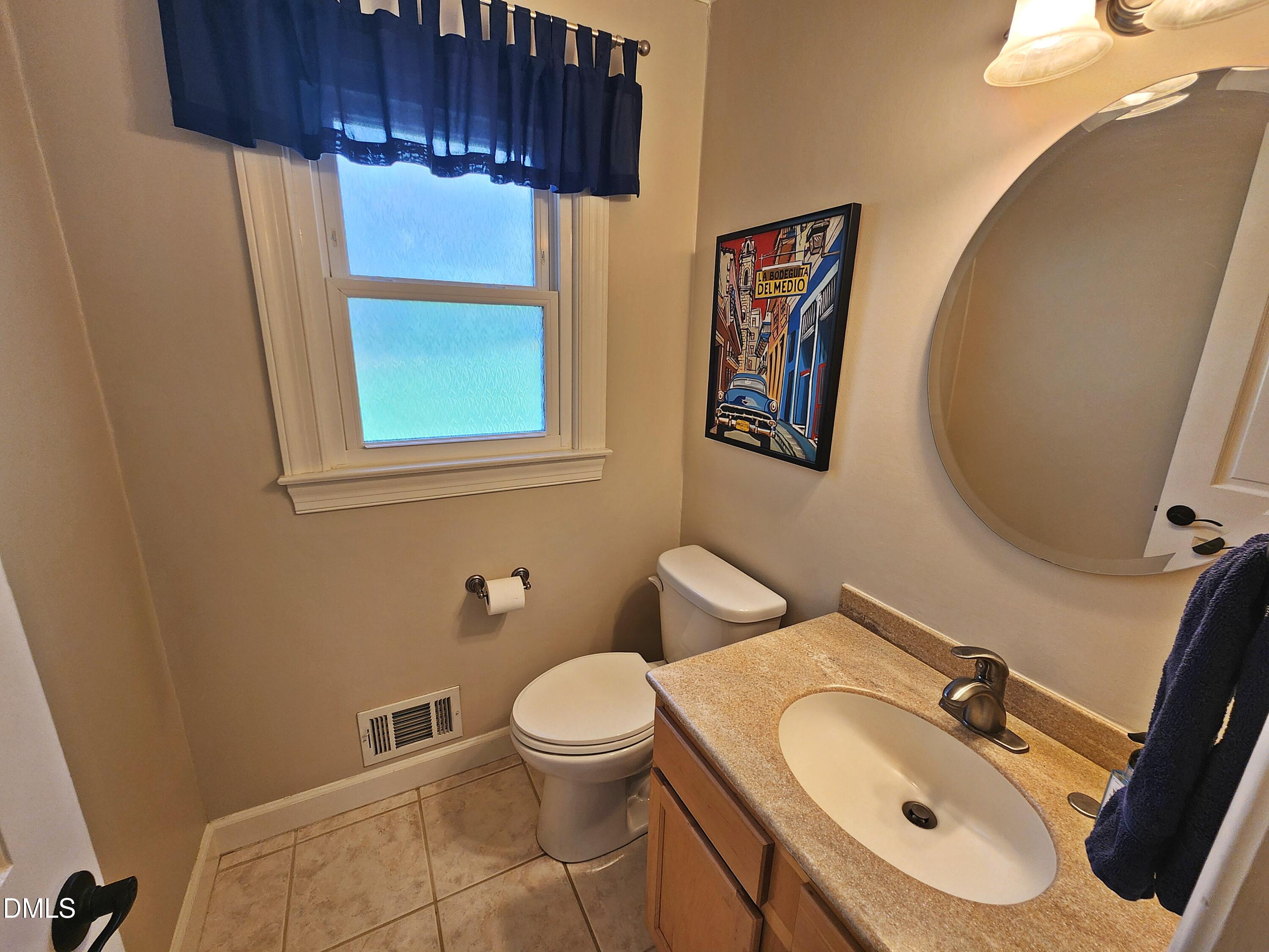 4704 Oak Park Road Raleigh, NC 27612 - Photo 31 of 62 a bathroom with a sink mirror and toilet
