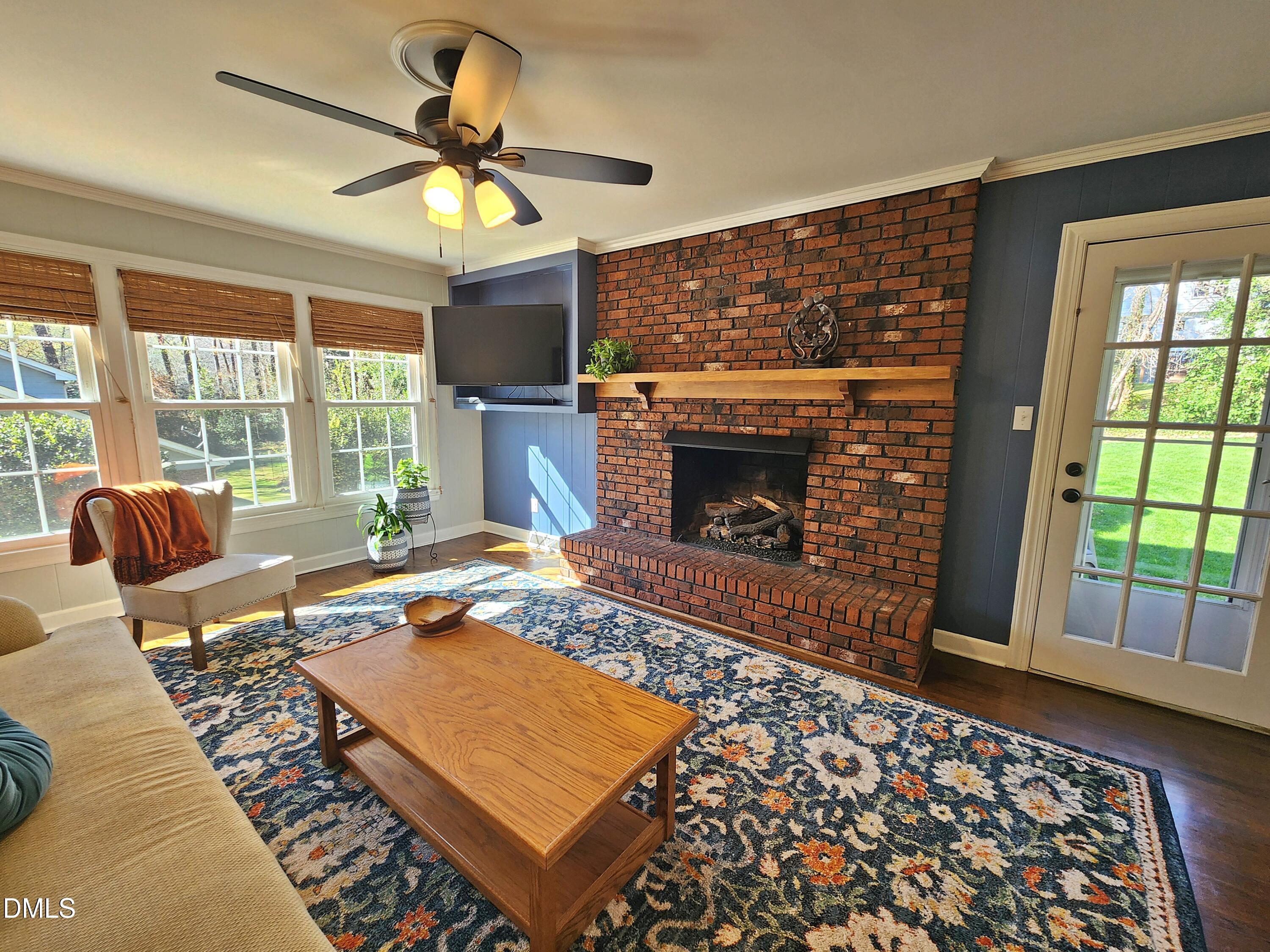 4704 Oak Park Road Raleigh, NC 27612 - Photo 32 of 62 a living room with furniture a rug and a fireplace