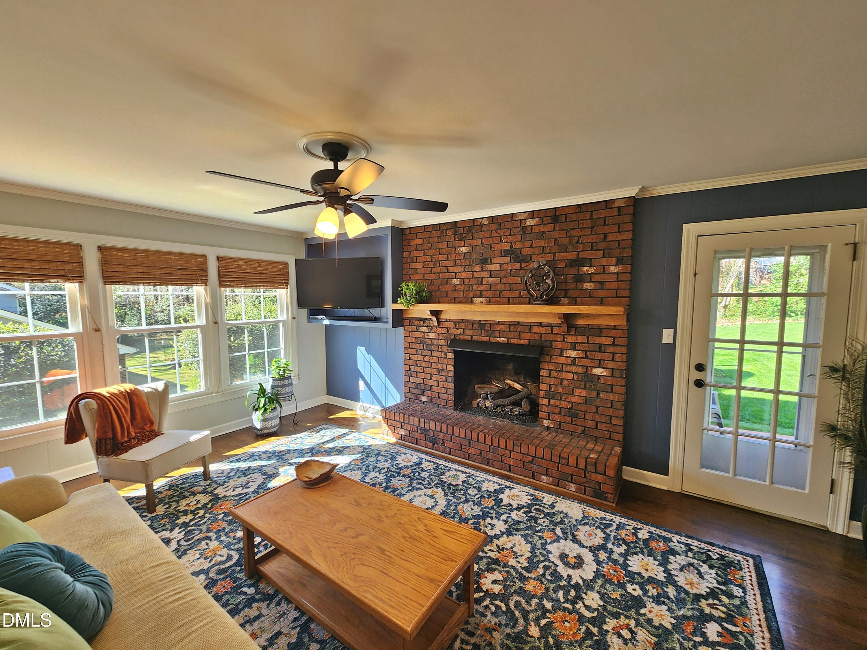 4704 Oak Park Road Raleigh, NC 27612 - Photo 34 of 62 a living room with furniture and a fireplace