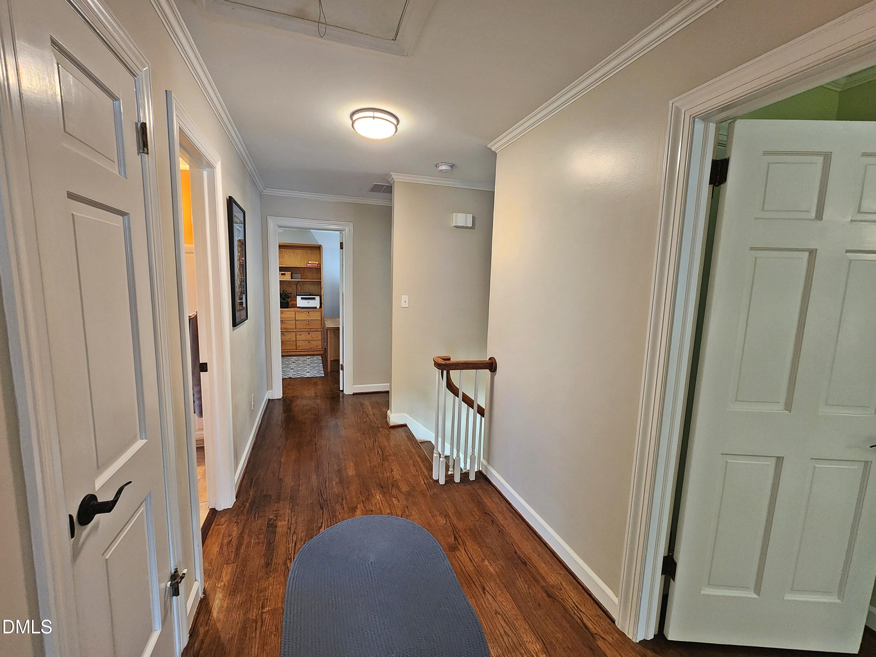 4704 Oak Park Road Raleigh, NC 27612 - Photo 36 of 62 a view of a hallway with wooden floor and staircase