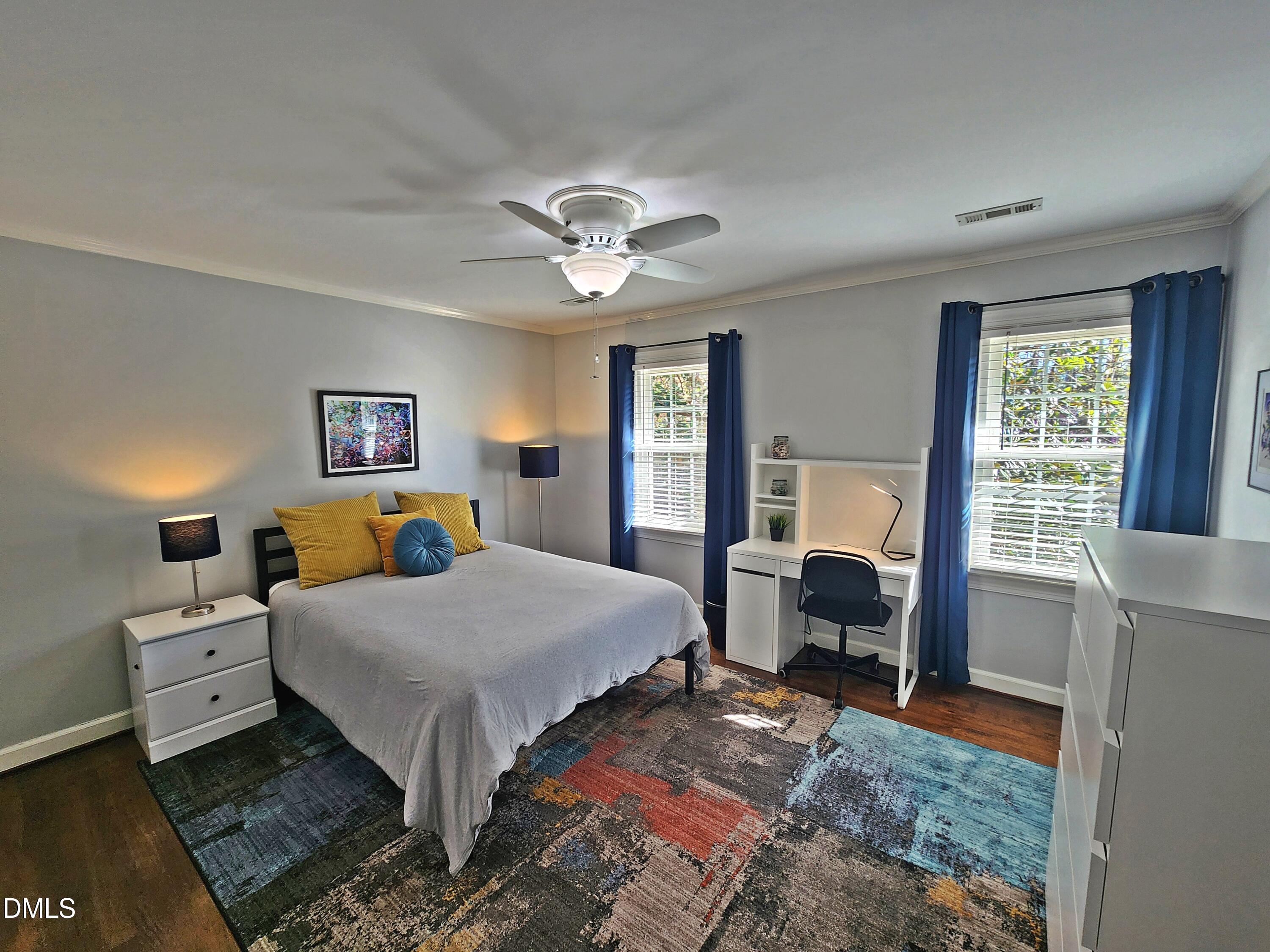 4704 Oak Park Road Raleigh, NC 27612 - Photo 37 of 62 a bedroom with a bed and a chandelier