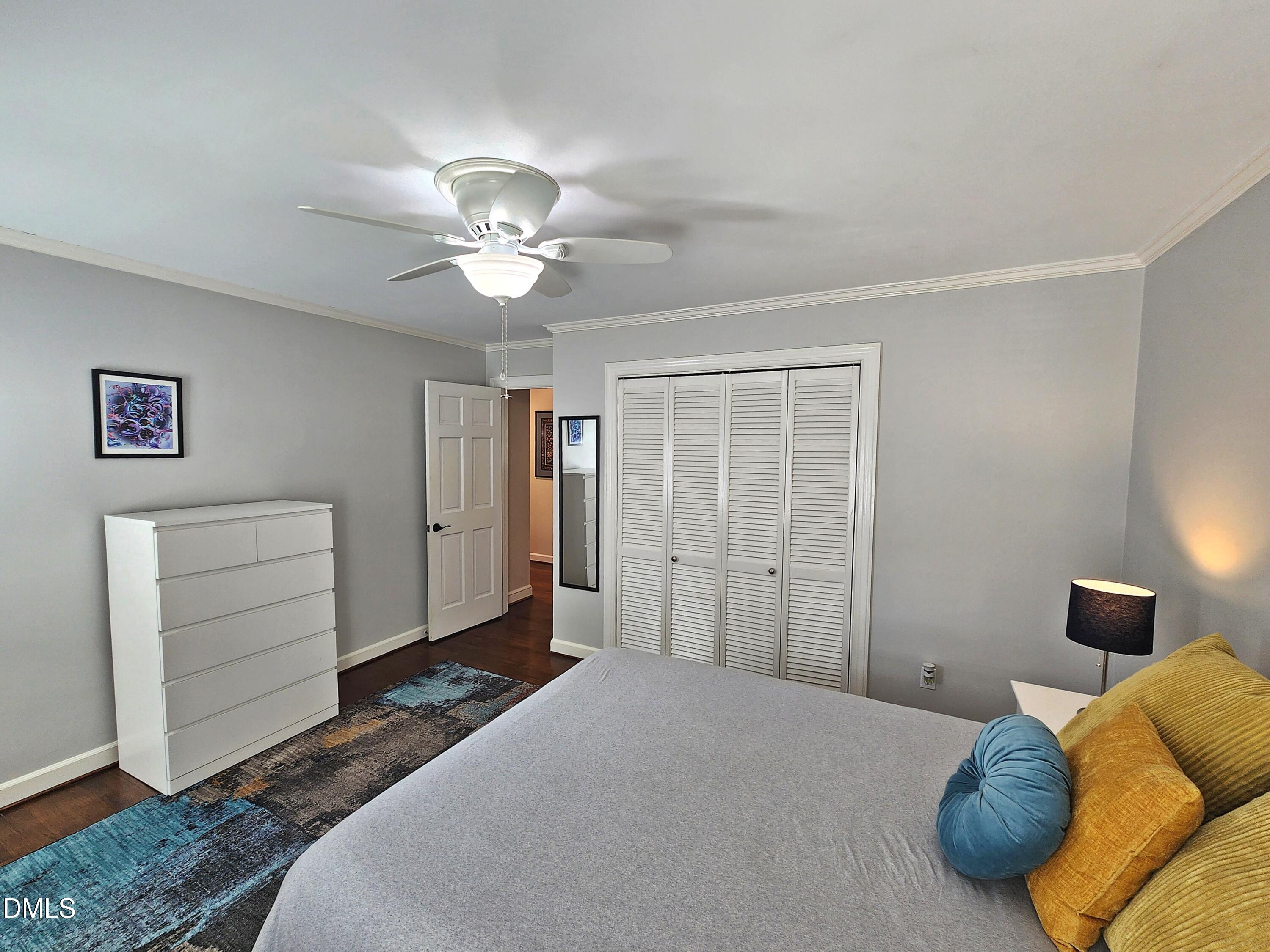 4704 Oak Park Road Raleigh, NC 27612 - Photo 38 of 62 a bedroom with a bed and a chandelier