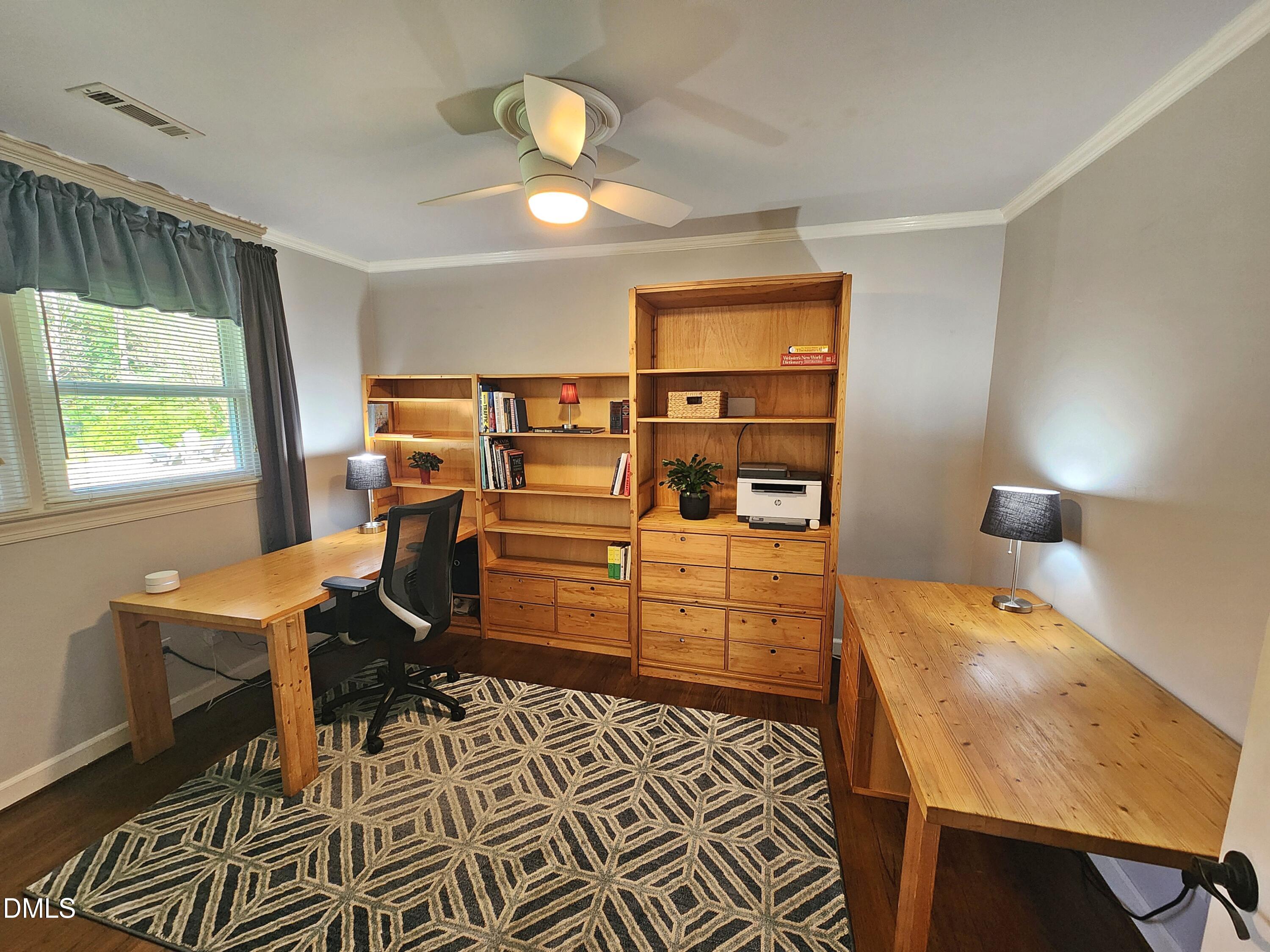 4704 Oak Park Road Raleigh, NC 27612 - Photo 39 of 62 a bedroom with a bed and a table in it