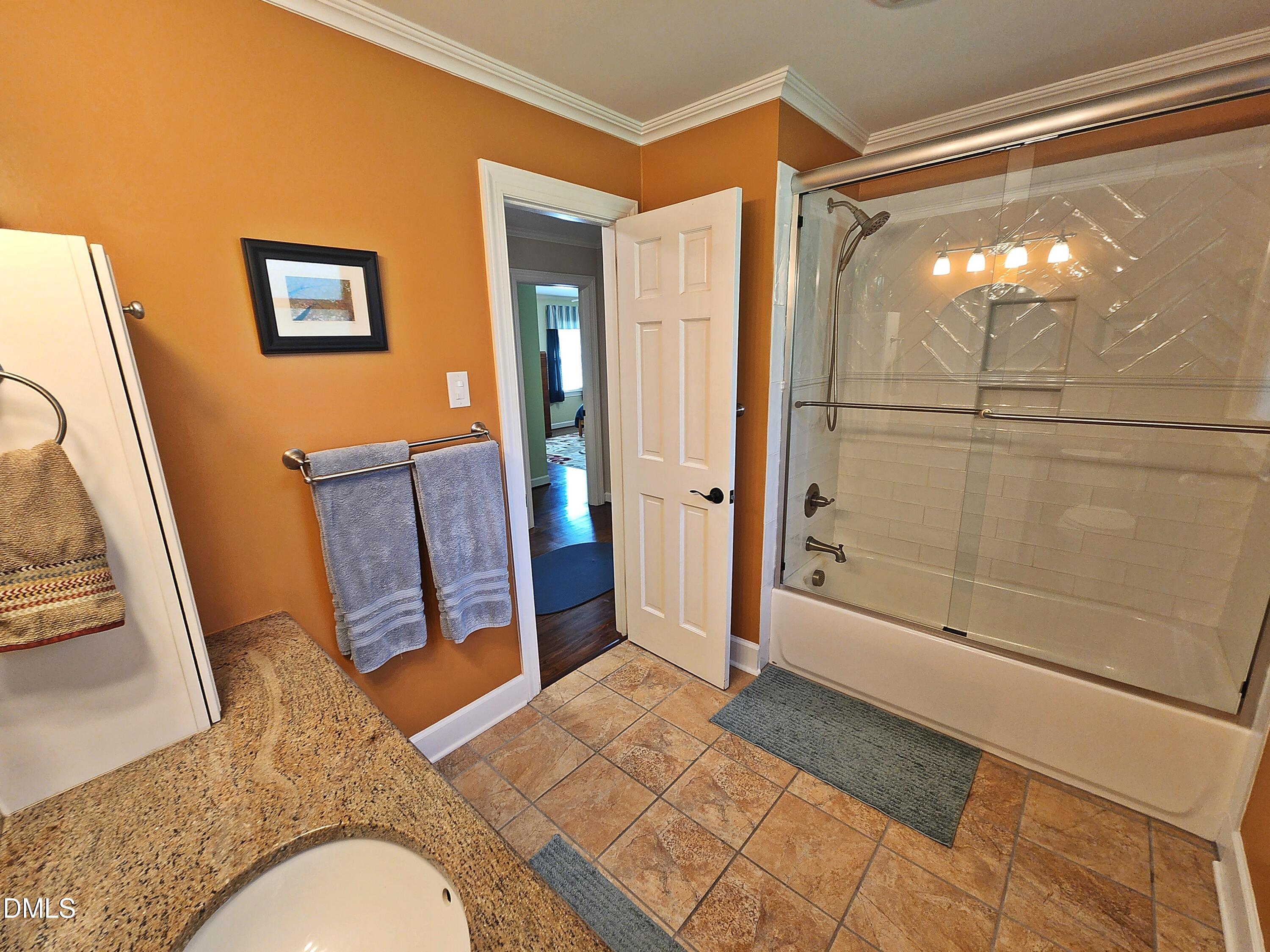 4704 Oak Park Road Raleigh, NC 27612 - Photo 45 of 62 a bathroom with a sink and glass door shower